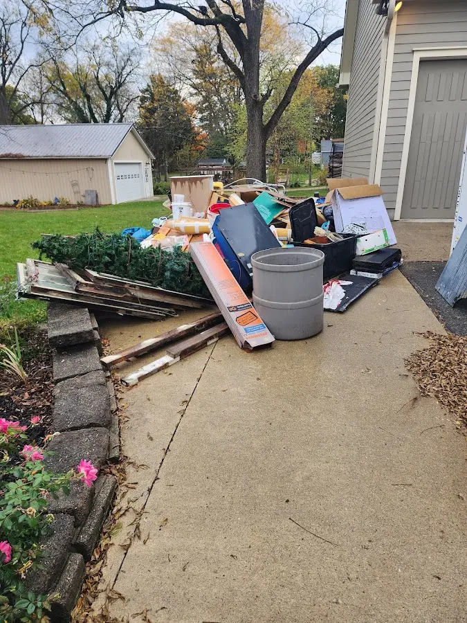 Dumpster being loaded with debris for Roofing Dumpster Rental in Farmersville